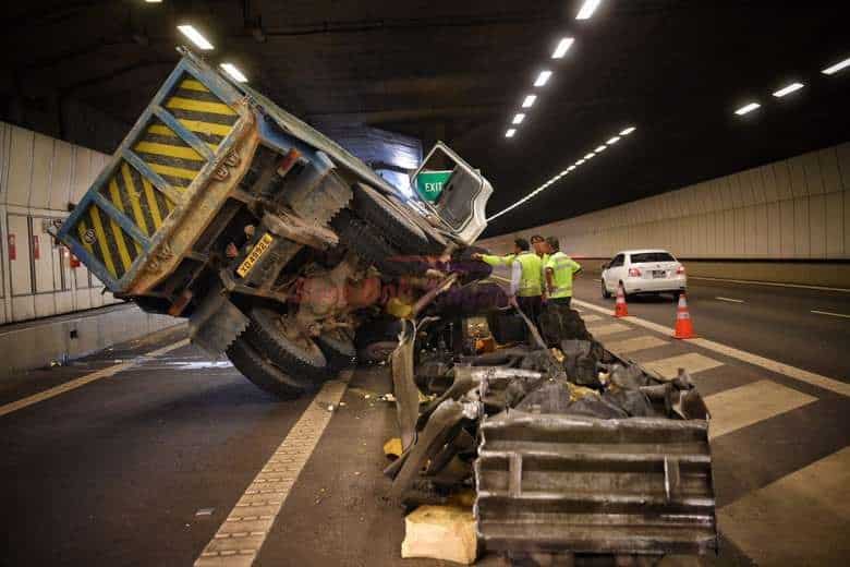 Singapore: A construction tipper truck tilted on its left side in the KPE tunnel