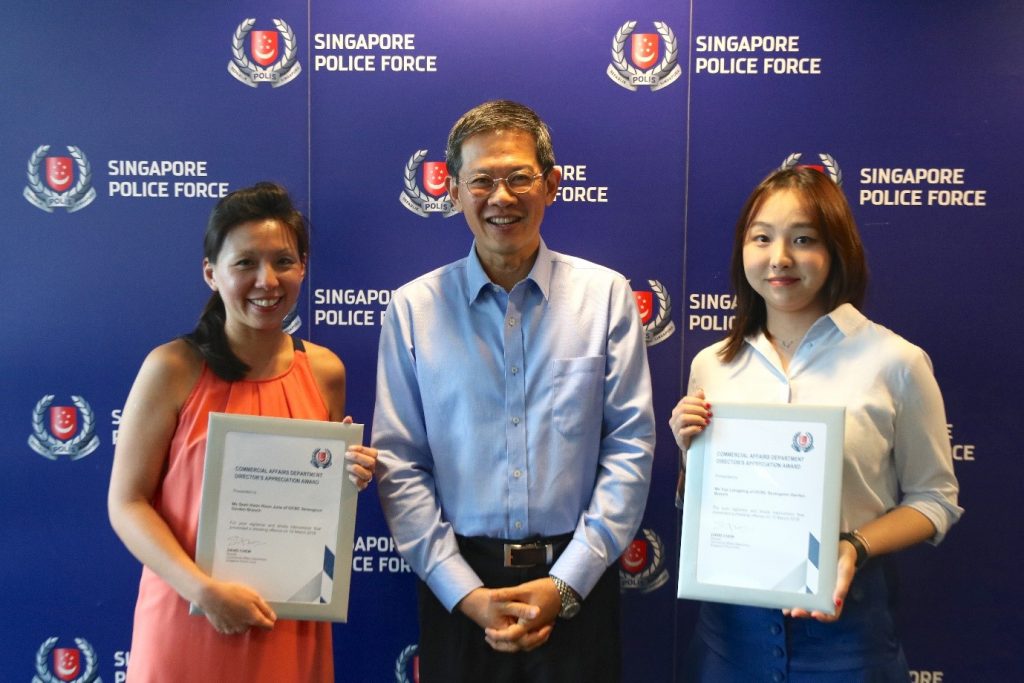 Director CAD Mr. David Chew with OCBC staff, Ms Seah Hoon Hoon June (left) and Ms Yao Liang Bing (right)