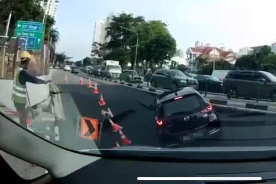 A car was making a left turn into the junction when it suddenly fell into a sinkhole that appeared without warning.