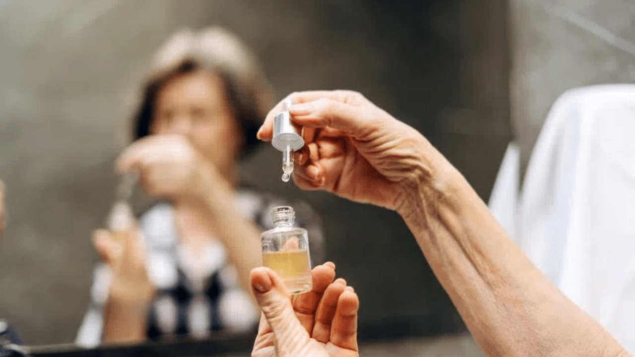 Hand sanitizer being poured into a small bottle for hygiene and safety.